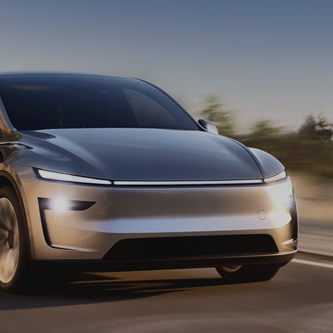 Tesla Model Y driving on a road with a blurred background