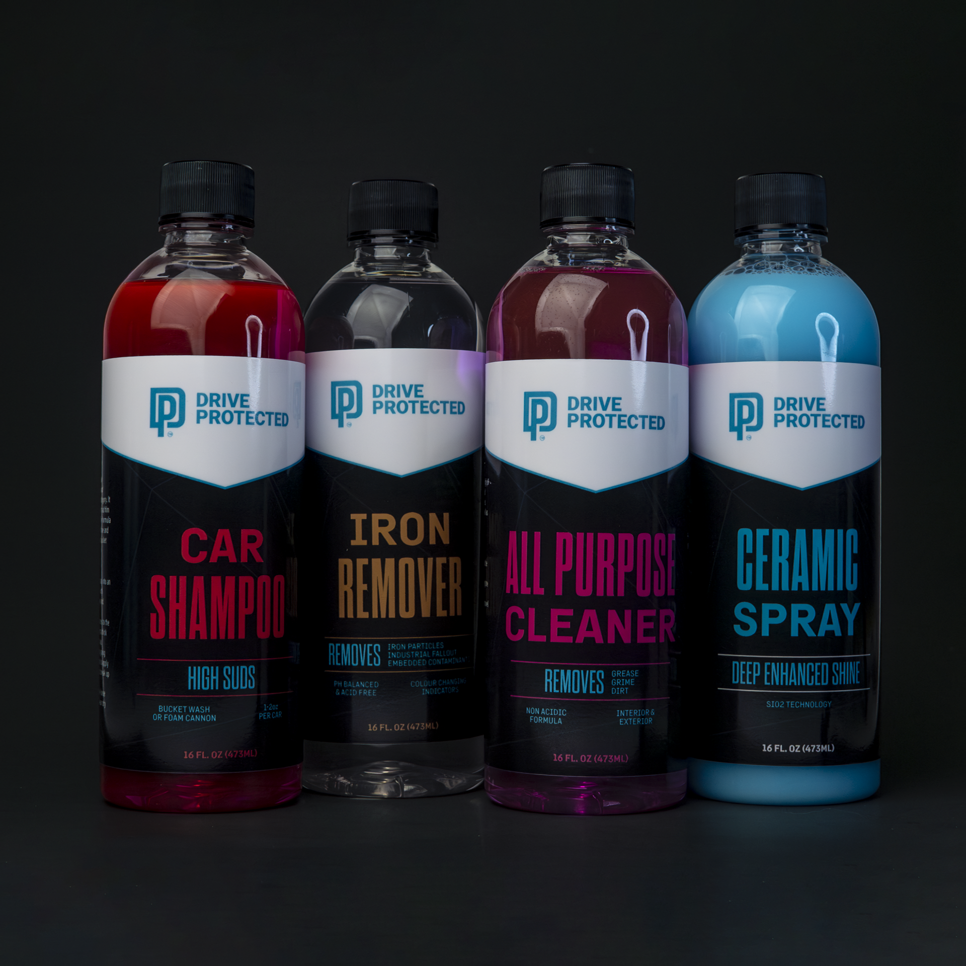 Four bottles of Drive Protected car care products on a dark background