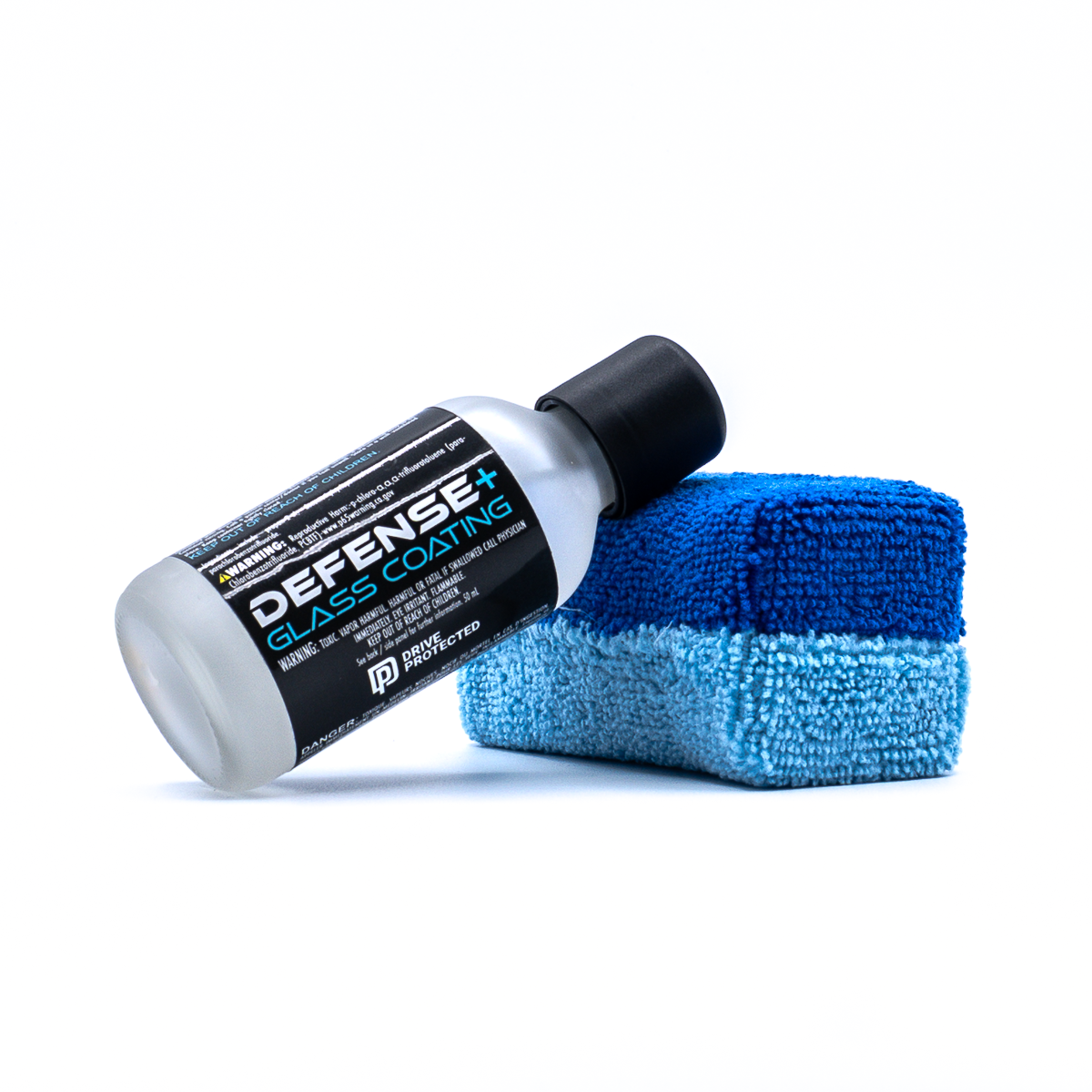 Bottle of Defense+ Glass Coating by Drive Protected leaning against an applicator pa