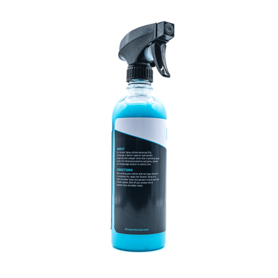 Spray bottle with blue liquid and black nozzle on a white background