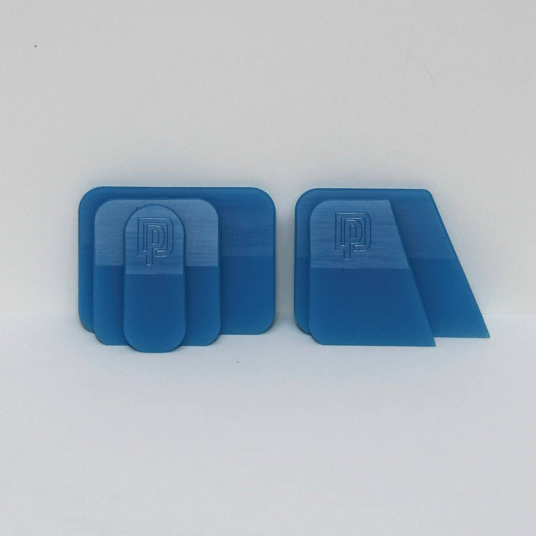 Five blue plastic squeegees on a white background