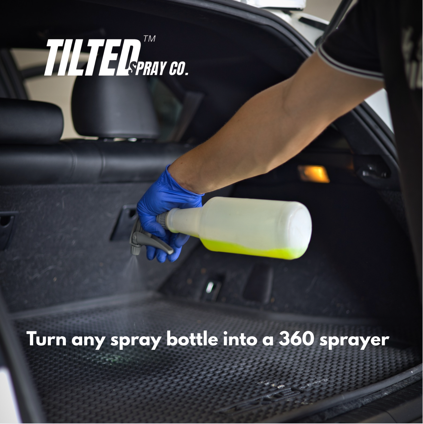 Person using a spray bottle with a Tilted Spray Co. attachment inside a car.